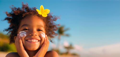 Young African-American girl with sunscreen smiling on a sunny beach. Banner with copy space. Concept of skincare, summer safety, outdoor activities