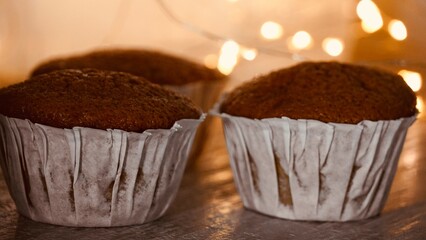 Fresh homemade muffins with lights in the background.