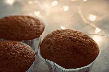 Fresh homemade muffins with lights in the background.