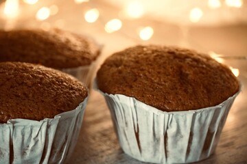 Fresh homemade muffins with lights in the background.