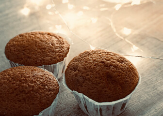 Fresh homemade muffins with lights in the background.