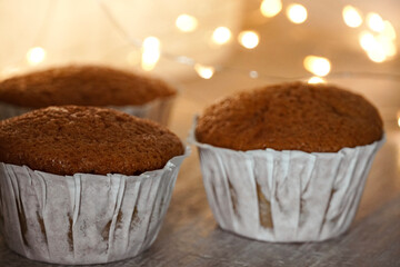 Fresh homemade muffins with lights in the background.