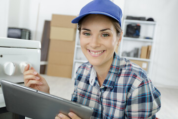 portrait of female worker using digital tablet and smiling