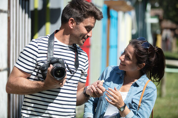 miling couple with photo camera in the city