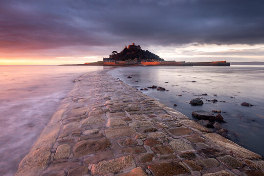 Causeway leading to St Michael's Mount, at sunrise. Marazion, Cornwall, England, UK. January 2014. 