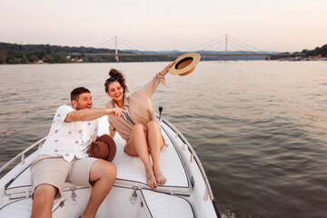 Couple relaxing while sailing on a boat
