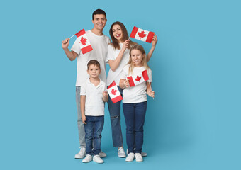 Happy family with flags of Canada on blue background