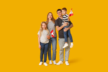 Happy family with flags of Canada on yellow background