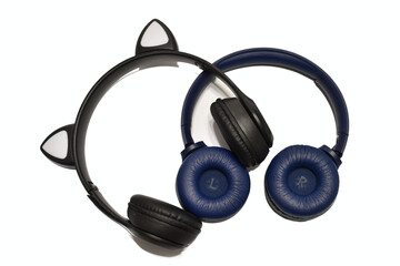 Two black wireless headphones lie on a white background.