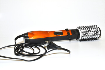 Hair dryer brush for creating volume in a woman's hairstyle.