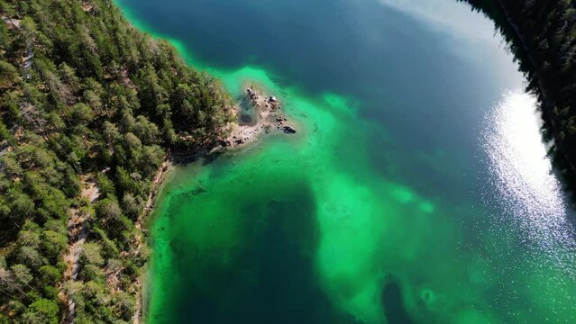 Aerial Drone Footage 4k of Blindsee Lake in Germany Austria Tirol Turquoise Green Water with forest and mountains around the lake. High quality 4k footage