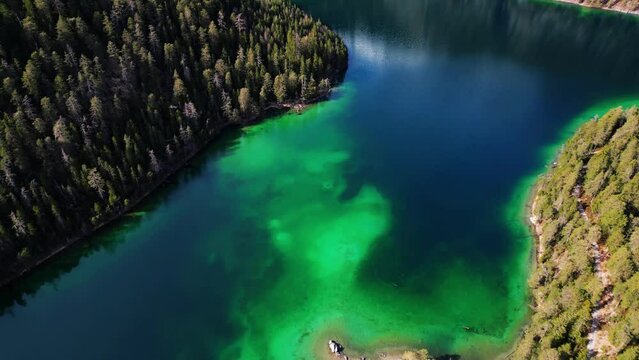Aerial Drone Footage 4k of Blindsee Lake in Germany Austria Tirol Turquoise Green Water with forest and mountains around the lake. High quality 4k footage