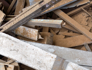 White wooden board lay on the leftover wooden pieces. Stacked together in a pile. Top view