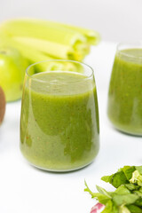 Healthy vegetable smoothie in glasses on white background.