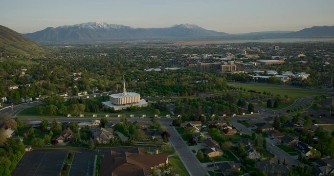 Epic wide shot flying over town and temple near mountains 