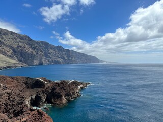 View of the Atlantic Ocean coast with Acantilados de Los Gigantes cliffs under the blue sky,...