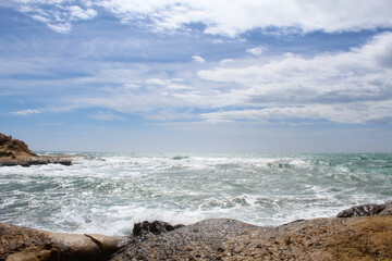 Fototapeta na wymiar natural background of sea sky and stones, beautiful view of Mediterranean coast in Spain, waves in the sea