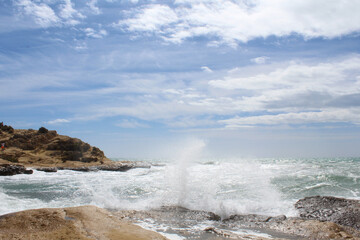 Fototapeta premium natural background of sea sky and stones, beautiful view of Mediterranean coast in Spain, waves in the sea