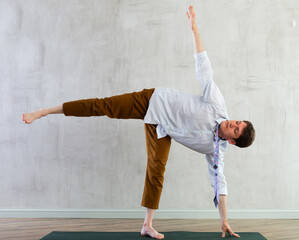 Yoga for office workers - man practicing yoga in office - 807811933