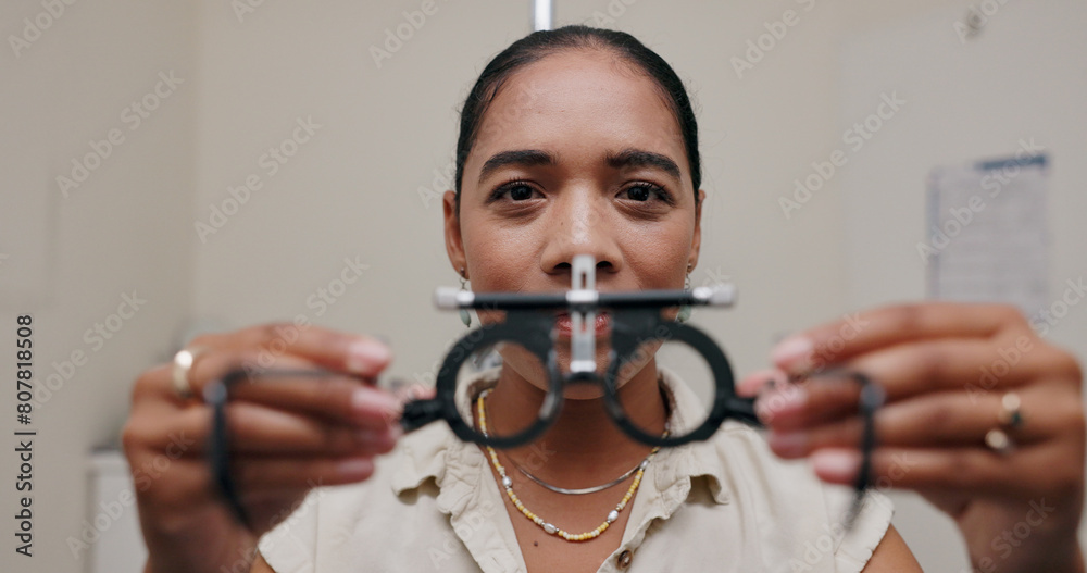 Wall mural Woman, optometrist and frame for eye care or equipment for examination, lens and vision testing. Closeup, tools and trial for diagnosis or eyesight with assessment, consultation and glasses with job