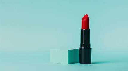 Red Lipstick on Turquoise Background with Cube Stand. Studio shot with space for text. Beauty and cosmetics concept for banner, advertisement, poster.