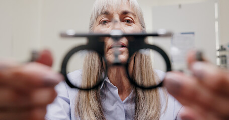 Mature woman, optometrist and frame for eye care or equipment for examination and vision testing....