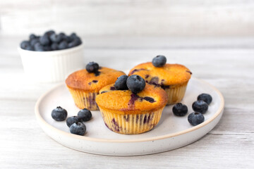 Blueberry muffins baked with fresh blueberries on a white  white background, close-up.  