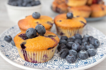 Blueberry muffins baked with fresh blueberries on a white  white background, close-up.  