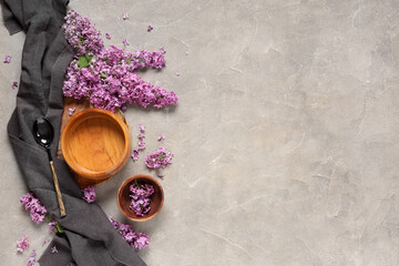 Beautiful table setting with lilac flowers on grey grunge background