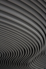 Vertical street photo. Wavy striped pattern on textured concrete stone gray wall. Concept of architecture, sculpture, sculpting, urbanism, brutality. City view. Copyspace for text. Abstract background