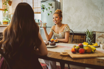 Warm Breakfast Chat in a Bohemian Kitchen Between Two Young Women