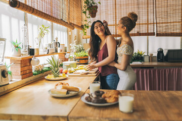 Joyful Moments: Friends Preparing Breakfast Together in a Sunlit Kitchen