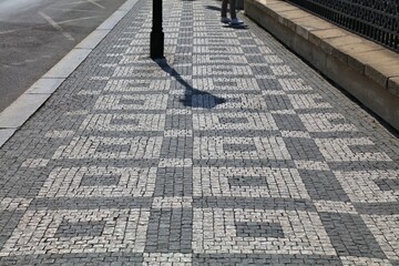 Sidewalk cobblestone pavement patterns in Prague city