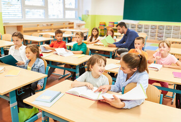 Schoolgirl having fun while studying in class