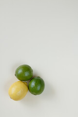 A lemon and two limes on a white background.