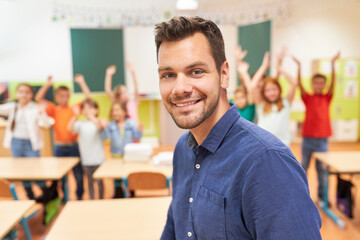 Smiling teacher with students in background