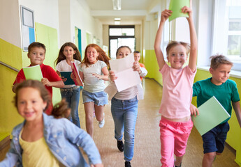 Elementary students running in hallway at school