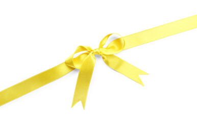 Fototapeta premium Yellow satin ribbon with bow on white background, top view