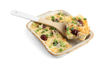 Taking piece of tasty sausage casserole with green onion from baking dish isolated on white