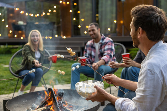 Diverse friends making picnic in the backyard