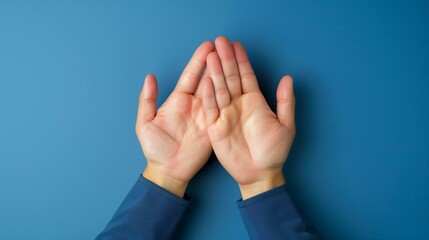 two hands with palms up in cupping gesture on blue background, wishing yearning longing desiring craving