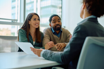 Multiracial couple having  meeting with bank manager in office.