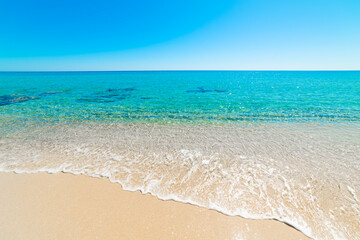 Beach with turquoise water and white sand on a sunny day