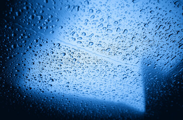 Raindrops on blue metallic surface texture background