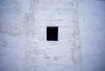 Small window in cement wall background