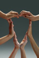 Group of diverse kids connected together shaped as support symbol expressing feeling of love...