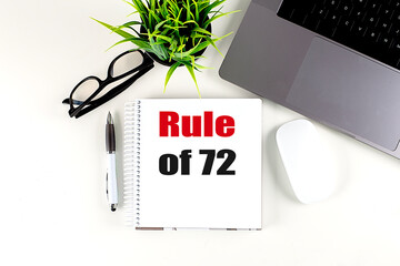 RULE OF 72 text on notebook with laptop, mouse and pen
