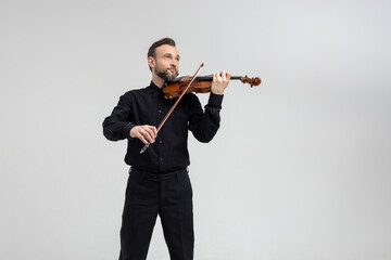 Elegant musician man violinist playing on concert