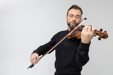 Attractive bearded violist man playing instrument