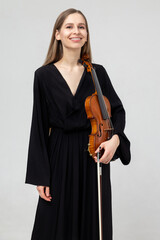 Portrait of attractive woman musician playing violin © zinkevych